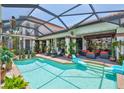 The backyard features an oversized pool and deck, with lounge chairs and an outdoor dining area at 5417 Tybee Island Dr, Apollo Beach, FL 33572