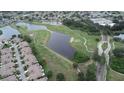 Scenic aerial view showcasing the golf course community with ponds, lush greenery, and well-maintained residential areas at 611 Tremont Greens Ln, Sun City Center, FL 33573