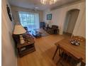 Bright living room featuring hardwood floors and a comfortable seating arrangement at 611 Tremont Greens Ln, Sun City Center, FL 33573