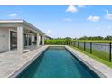 Inviting in-ground pool with lakeside views, perfect for relaxation and outdoor enjoyment on a sunny day at 6123 Golden Nettle Dr, Apollo Beach, FL 33572