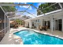Inviting screened-in pool area, perfect for relaxation and entertaining with covered patio at 613 Sportsman Park Dr, Seffner, FL 33584