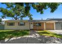 Charming single-story home with well-kept lawn, walkway, and garage at 6282 41St N Ave, St Petersburg, FL 33709