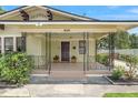 Inviting front porch boasts decorative iron railings and a cozy entrance at 909 E 15Th Ave, Tampa, FL 33605