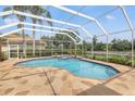 Inviting screened-in pool and patio area with stone flooring perfect for outdoor entertaining at 9348 Deer Creek Dr, Tampa, FL 33647