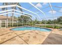 Inviting screened-in pool and patio area with stone flooring perfect for outdoor entertaining at 9348 Deer Creek Dr, Tampa, FL 33647