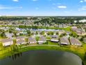 Wide aerial view showcasing a community with multiple homes near a lake at 10512 Fuzzy Cattail St, Riverview, FL 33578