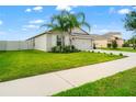Beautiful home with a well-manicured lawn and a two-car garage is surrounded by nice landscaping at 10512 Fuzzy Cattail St, Riverview, FL 33578