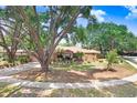 Beautiful single-story home with mature trees and lush landscaping at 107 Halton Cir, Seffner, FL 33584