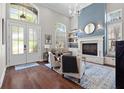 Bright living room features soaring ceilings, lots of natural light, fireplace, and elegant decor at 11723 Gothic Ln, Tampa, FL 33626