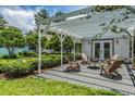 Inviting pergola patio with cozy seating and manicured greenery, ideal for relaxing and entertaining outdoors at 118 S Manhattan Ave, Tampa, FL 33609