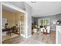 Open-concept living room with wood-look floors, neutral tones, and a view to the outside at 12009 Wandsworth Dr, Tampa, FL 33626