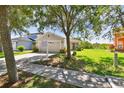 Well-kept single story home with a manicured lawn and an inviting walkway at 12716 Evington Point Dr, Riverview, FL 33579