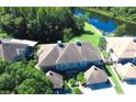 Aerial view of the home, showing the roof, backyard, and the nearby lake and trees at 14116 Trouville Dr, Tampa, FL 33624