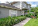 Charming home exterior with a garden, walkway, and a bicycle adding a touch of personality at 14116 Trouville Dr, Tampa, FL 33624