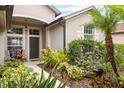 Inviting front porch with lush landscaping and cozy seating at 16104 Bridgedale Dr, Lithia, FL 33547