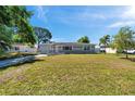 Landscaped front lawn showcases a charming single story home with an attached garage at 1732 63Rd N Ave, St Petersburg, FL 33702