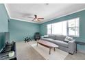 Inviting living room features a large window, ceiling fan, and comfortable seating area at 1732 63Rd N Ave, St Petersburg, FL 33702