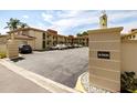 Exterior shot of the condo parking lot showing the 'Algiers' community sign and available parking spots at 19029 Us Highway 19 N # 5-14, Clearwater, FL 33764