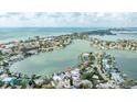 Panoramic aerial view of a waterfront property with a lush, green yard and stunning water views at 2010 20Th Avenue Pkwy, Indian Rocks Beach, FL 33785