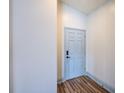 Bright hallway with wood floors leading to various rooms within the home at 22943 Sills Loop, Land O Lakes, FL 34639
