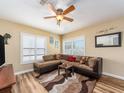 Cozy living room features a plush sectional sofa, decorative rug, and natural light at 2597 Countryside Blvd # 210, Clearwater, FL 33761
