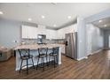 Modern kitchen boasts white cabinets, stainless steel appliances, granite countertops, and bar seating at 2816 Grand Kemerton Pl, Tampa, FL 33618