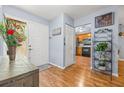 Inviting foyer with hardwood floors, leading to the kitchen with stainless steel appliances at 2919 Fig Ct, Palm Harbor, FL 34684
