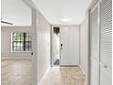 Bright foyer with tile flooring, closet space, and a front door with decorative window at 2986 Cypress Green Dr, Palm Harbor, FL 34684