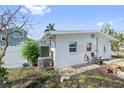 Exterior of home, showing the side, a small yard, and access to the street at 301 14Th Ave, Indian Rocks Beach, FL 33785
