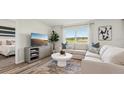 Inviting living room featuring a comfortable sectional sofa, ample natural light, and a serene atmosphere at 3050 Pink Gerbera Sq, Plant City, FL 33566