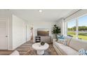 Cozy living room boasting neutral tones, stylish decor, and a view of the outdoors at 3050 Pink Gerbera Sq, Plant City, FL 33566