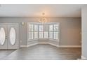 Bright dining area with tiled floors, features modern light fixture, and bay windows with plantation shutters at 4463 Vieux Carre Cir, Tampa, FL 33613