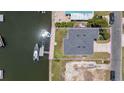 Aerial view showing property lines highlighting the home, boat dock, and proximity to the water at 4464 Neptune Dr, Hernando Beach, FL 34607