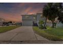 Charming two-story home featuring a spacious driveway, well-manicured lawn, and inviting curb appeal at 4464 Neptune Dr, Hernando Beach, FL 34607