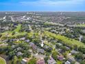 A beautiful aerial view highlighting the home's neighborhood, nearby shopping, and green golf courses at 465 Holly Hill Rd, Oldsmar, FL 34677