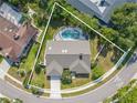 An aerial shot showcasing the property's layout, private pool, and surrounding lush greenery at 465 Holly Hill Rd, Oldsmar, FL 34677