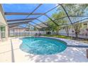Inviting screened-in pool area featuring a sparkling pool and ample space for relaxation and entertainment at 465 Holly Hill Rd, Oldsmar, FL 34677