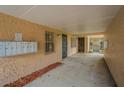 Exterior entryway showcasing mailboxes, a security door, and concrete flooring at 4708 Michael Ct # 103, Tampa, FL 33614