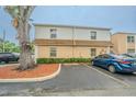 Exterior view of the well-maintained condos featuring assigned parking and mature landscaping at 4708 Michael Ct # 104, Tampa, FL 33614