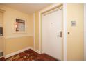 Hallway entrance features unit number 613, fire extinguisher, and decorative carpet at 4900 Brittany S Dr # 613, St Petersburg, FL 33715