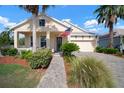 Charming one-story home with a well-kept lawn, pretty landscaping, and a convenient attached two-car garage at 5102 Coastal Scene Dr, Apollo Beach, FL 33572