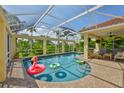 Screened-in pool with a brick deck, outdoor seating, and surrounding tropical foliage at 6468 Rubia Cir, Apollo Beach, FL 33572
