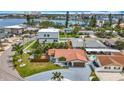 Aerial view of a single Gathering home with a red tile roof in a neighborhood near the water and downtown at 7125 S Shore S Dr, St Petersburg, FL 33707