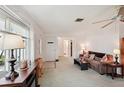 Bright living room with a cozy sofa, large window, and an electric fireplace creating a warm ambiance at 953 Tropical Nw Ave, Port Charlotte, FL 33948
