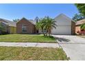 Charming single-Gathering home with a brick facade, two-car garage, well-manicured lawn, and palm tree at 9709 Bay Colony Dr, Riverview, FL 33578