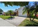 Charming single-Gathering home with lush landscaping, a brick facade, and a two-car garage at 9709 Bay Colony Dr, Riverview, FL 33578