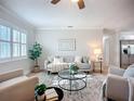 Inviting living room featuring plantation shutters, hardwood floors, and neutral decor, perfect for relaxing or entertaining at 9929 Bay Dr, Gibsonton, FL 33534