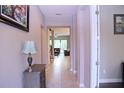 Inviting hallway leads to a spacious living area with tiled flooring and neutral paint at 10431 Alcon Blue Dr, Riverview, FL 33578