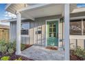 Close-up of a charming front porch with a cheerful green door and welcoming 