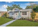 Well-maintained home with landscaping, a manicured lawn and a bright front door at 1052 55Th N Ave, St Petersburg, FL 33703
